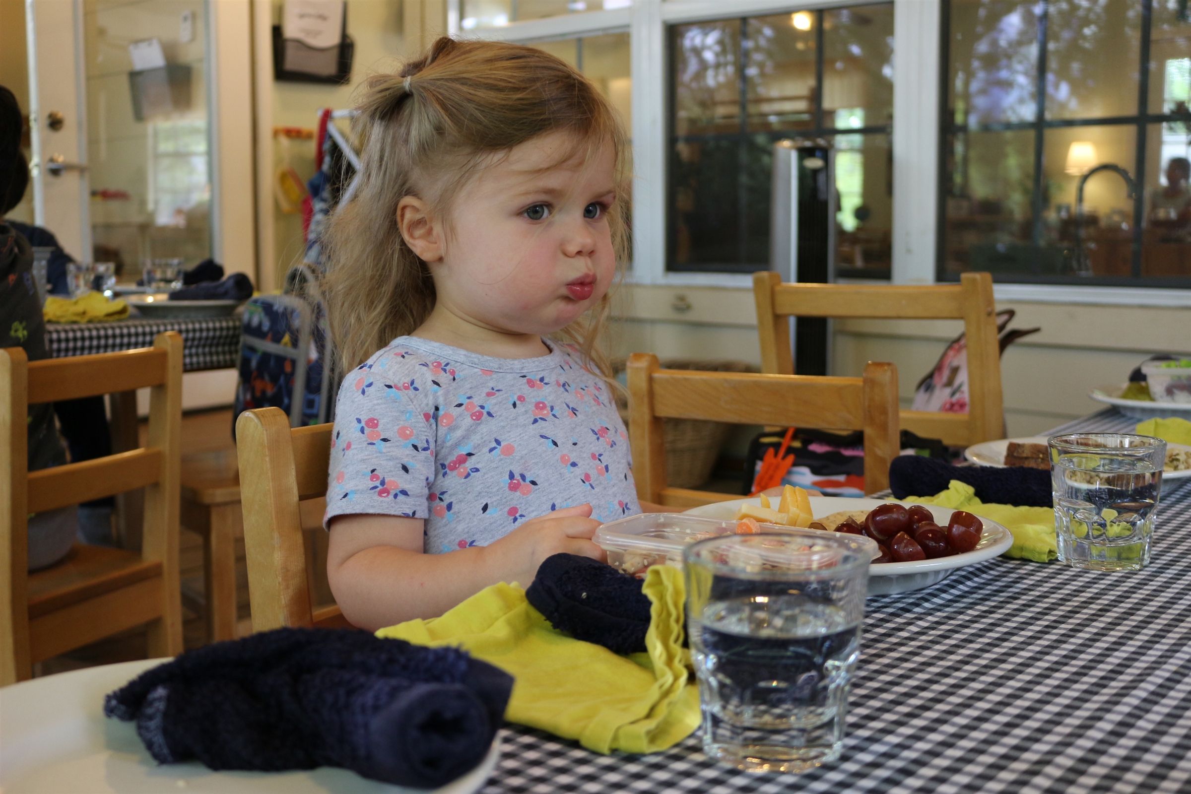 A child preparing and sharing food in the classroom at Austin Montessori School