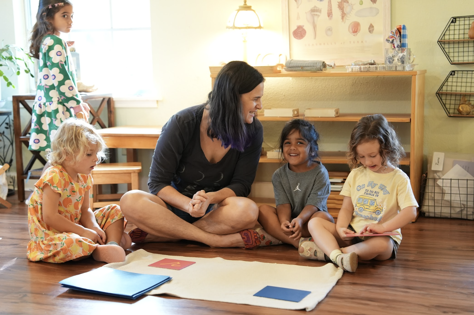 A Guide and children at work in the Children's House
