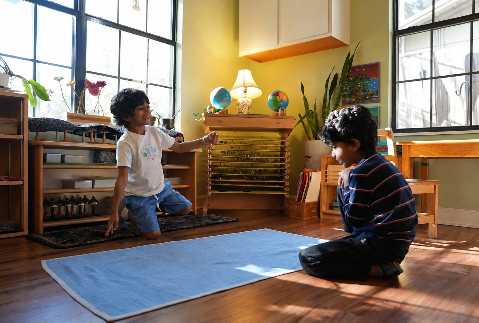 Two children working together with the bead chains